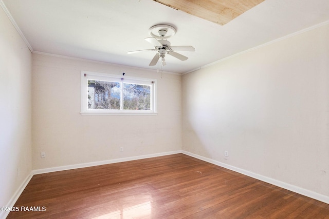 spare room with baseboards, wood finished floors, a ceiling fan, and ornamental molding