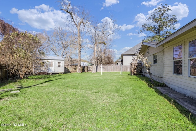 view of yard with an outbuilding and a fenced backyard