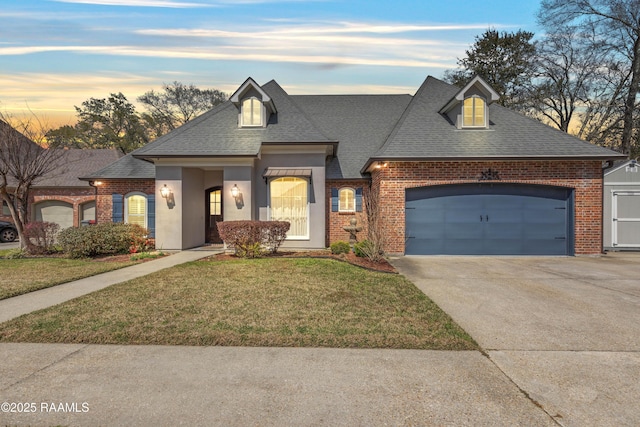 view of front of home with a garage, a lawn, brick siding, and driveway