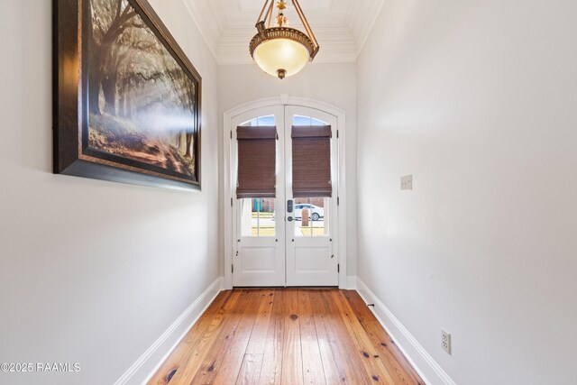 entryway with french doors, crown molding, baseboards, and hardwood / wood-style flooring