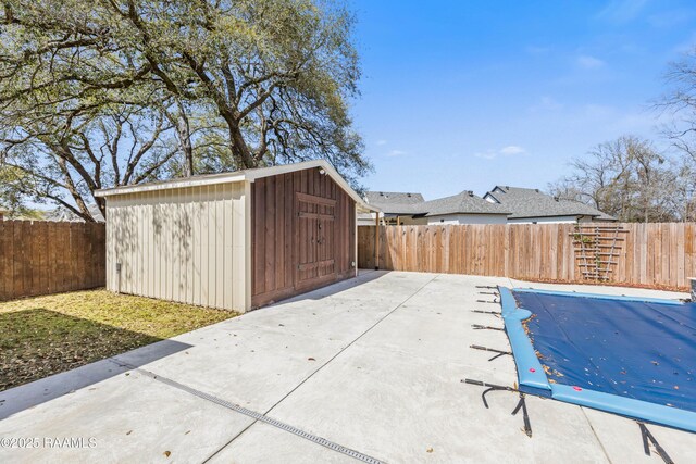 view of shed with a fenced backyard