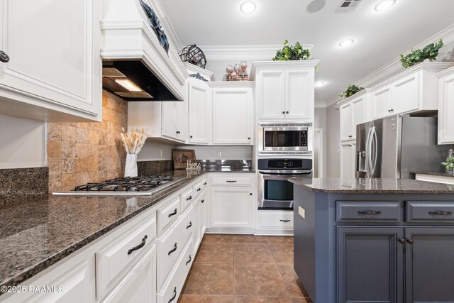 kitchen featuring crown molding, white cabinets, gray cabinets, and stainless steel appliances