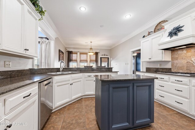 kitchen featuring ornamental molding, white cabinetry, stainless steel appliances, and a sink