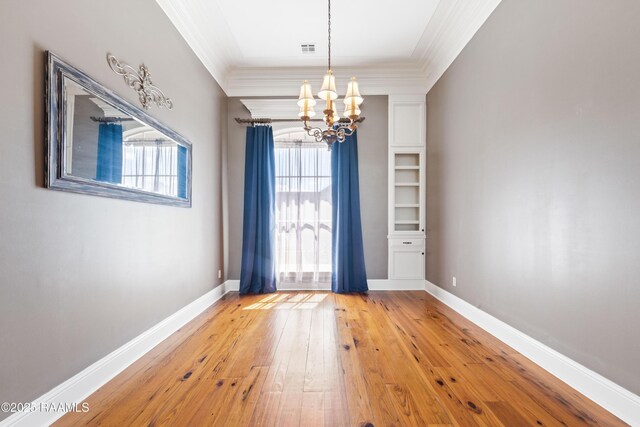 interior space featuring visible vents, crown molding, and baseboards