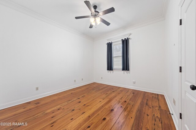 spare room with hardwood / wood-style flooring, crown molding, baseboards, and ceiling fan