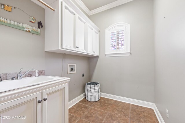 clothes washing area featuring crown molding, baseboards, washer hookup, cabinet space, and electric dryer hookup