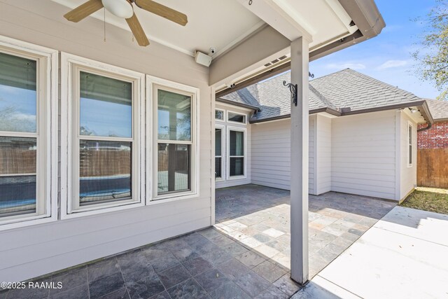 view of patio with fence and ceiling fan