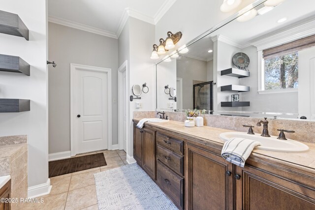 bathroom with tile patterned floors, a sink, crown molding, a shower stall, and double vanity