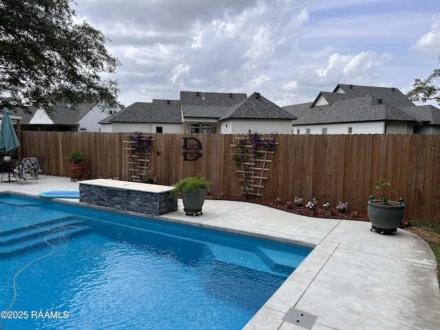 view of pool with a fenced in pool, a fenced backyard, and a patio area