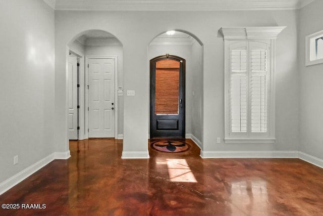 entryway with baseboards, arched walkways, and finished concrete floors