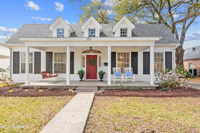 view of front of house with a porch, a front yard, and roof with shingles