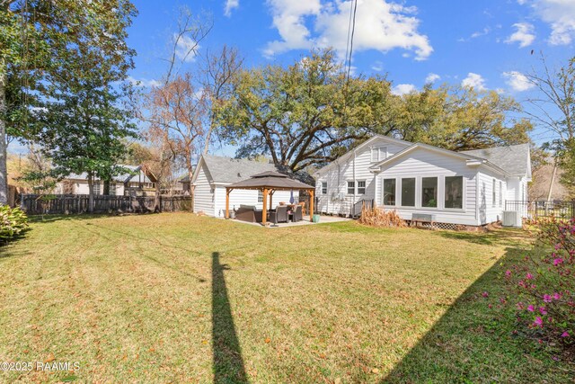 rear view of property featuring central air condition unit, a gazebo, a yard, a fenced backyard, and a patio