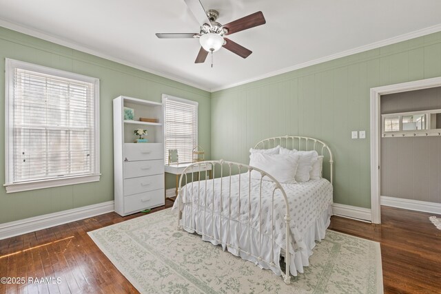 bedroom with a ceiling fan, crown molding, baseboards, and wood-type flooring