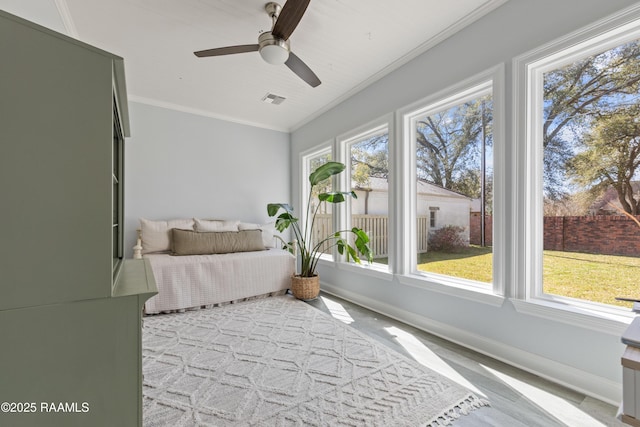 bedroom featuring ceiling fan, baseboards, visible vents, and ornamental molding