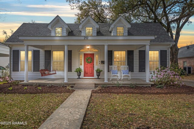 view of front of property with covered porch and a shingled roof