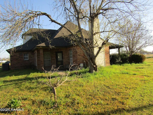 view of home's exterior featuring a yard and brick siding