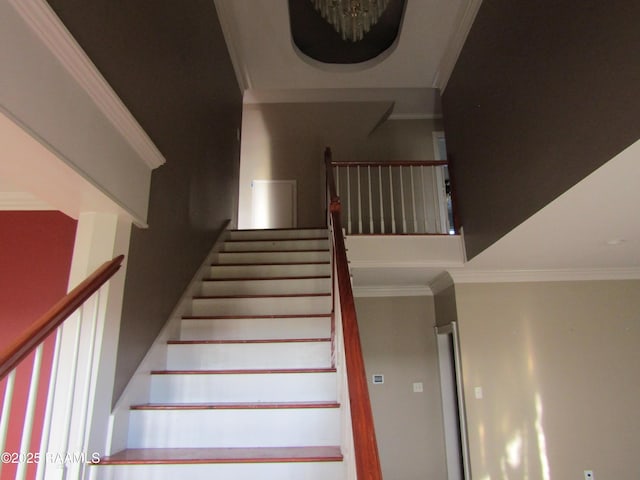 stairs featuring crown molding