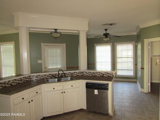 kitchen with a sink, stainless steel dishwasher, a peninsula, and crown molding