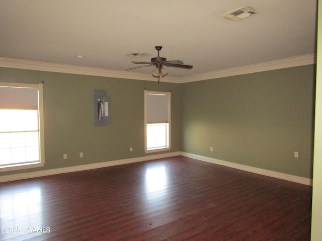 empty room with visible vents, crown molding, and dark wood-style flooring