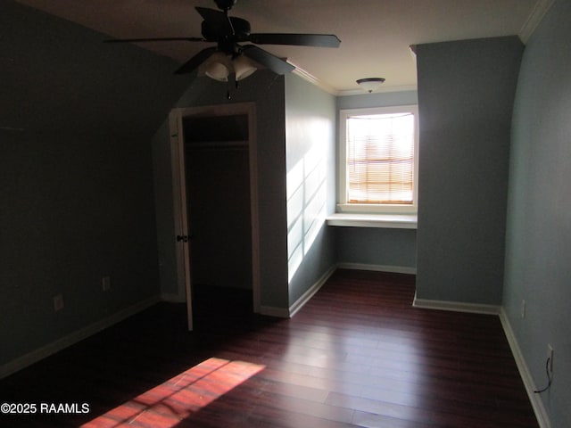 interior space with ceiling fan, wood finished floors, baseboards, and ornamental molding