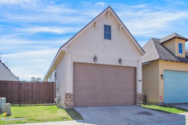 garage featuring fence and driveway