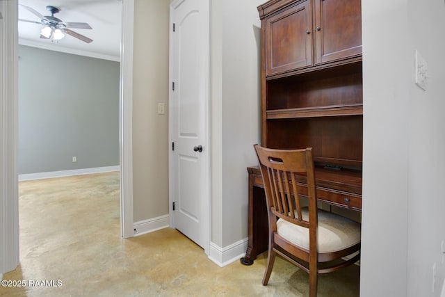 office space with a ceiling fan, baseboards, concrete floors, and ornamental molding