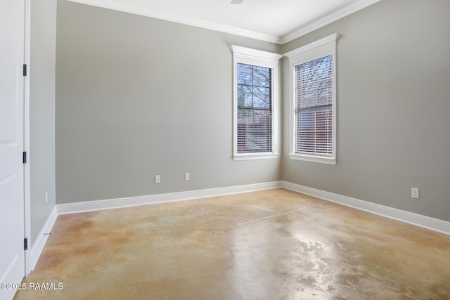 spare room featuring baseboards, concrete flooring, and ornamental molding