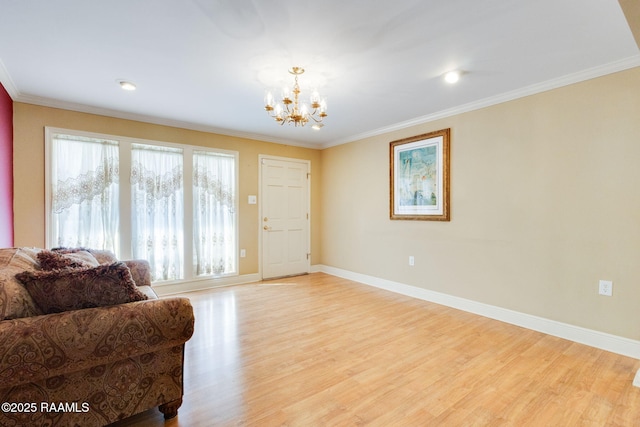 sitting room featuring baseboards, a notable chandelier, light wood-style flooring, and ornamental molding