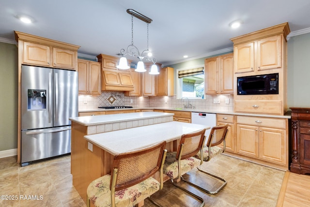 kitchen featuring ornamental molding, light brown cabinetry, stainless steel fridge, black microwave, and light countertops