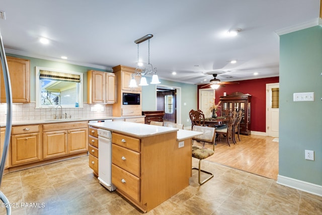 kitchen featuring backsplash, light countertops, black microwave, and a sink