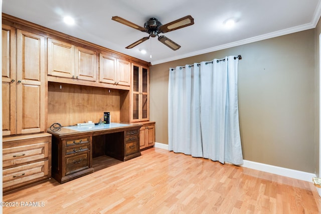 office space with light wood finished floors, baseboards, crown molding, and a ceiling fan