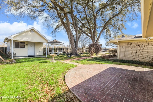 view of yard featuring a gazebo, a patio, and fence