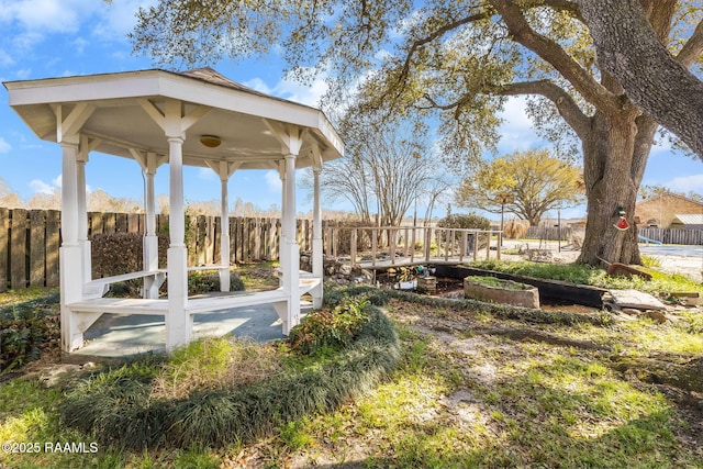 view of yard with a gazebo, a vegetable garden, and fence