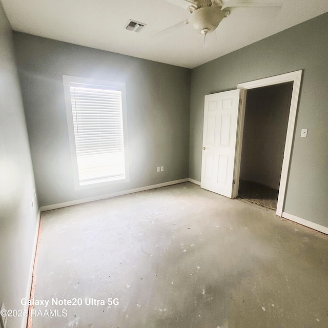 unfurnished bedroom featuring visible vents, baseboards, concrete floors, and a ceiling fan