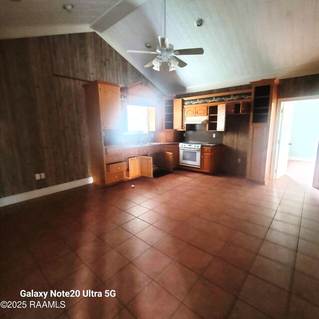 kitchen featuring white electric range oven, wooden walls, a ceiling fan, lofted ceiling, and under cabinet range hood