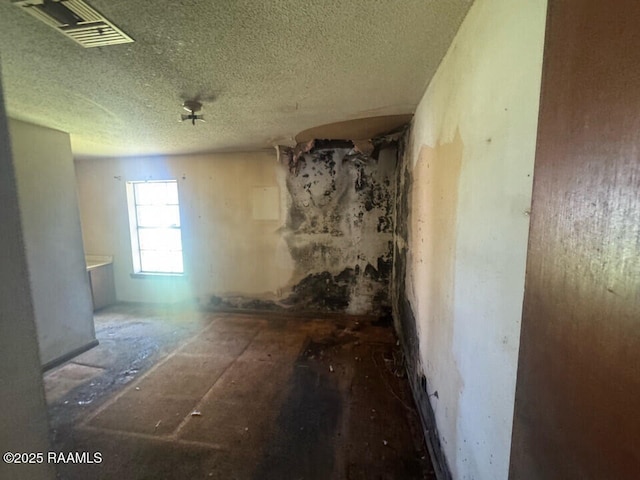 empty room with visible vents and a textured ceiling