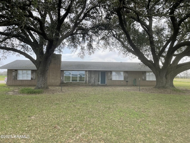 ranch-style home with brick siding and a front yard