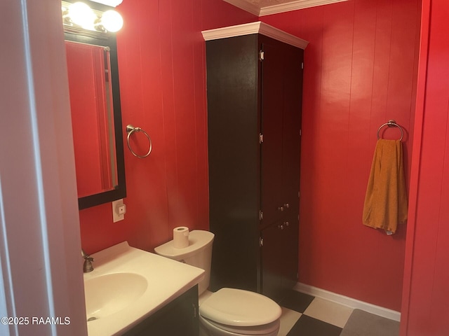 bathroom featuring tile patterned floors, baseboards, toilet, and vanity