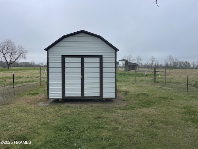 view of shed with a rural view