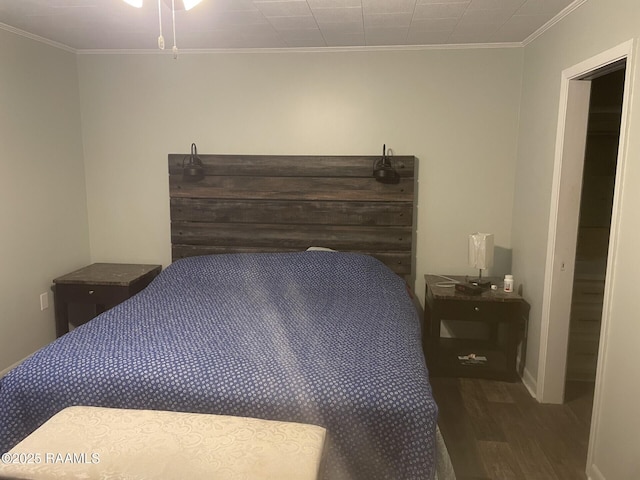 bedroom featuring wood finished floors and crown molding