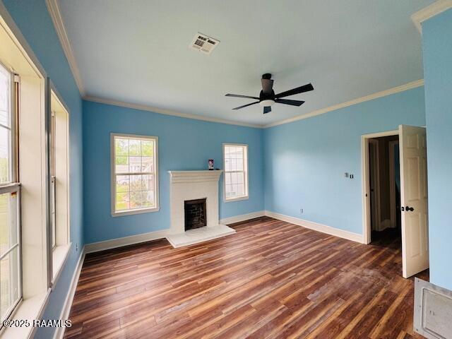 224 W Cherry St, Opelousas, LA 70570 - unfurnished living room featuring crown molding, visible vents, a fireplace with raised hearth, and wood finished floors