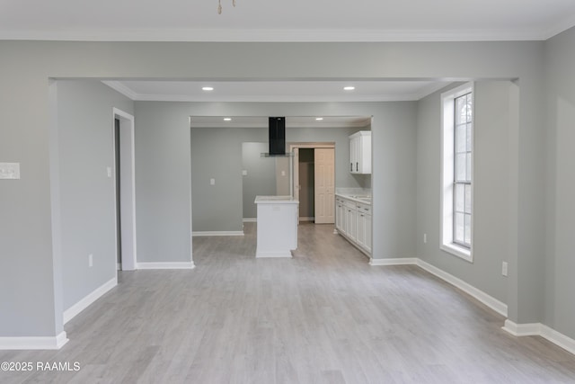 unfurnished living room featuring a healthy amount of sunlight and baseboards