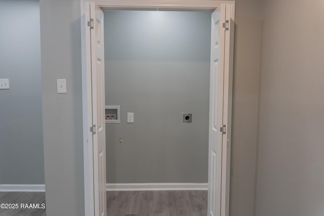 laundry area featuring hookup for a washing machine, hookup for an electric dryer, baseboards, and wood finished floors