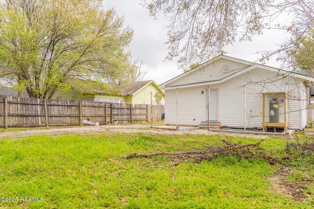 view of yard with entry steps and fence