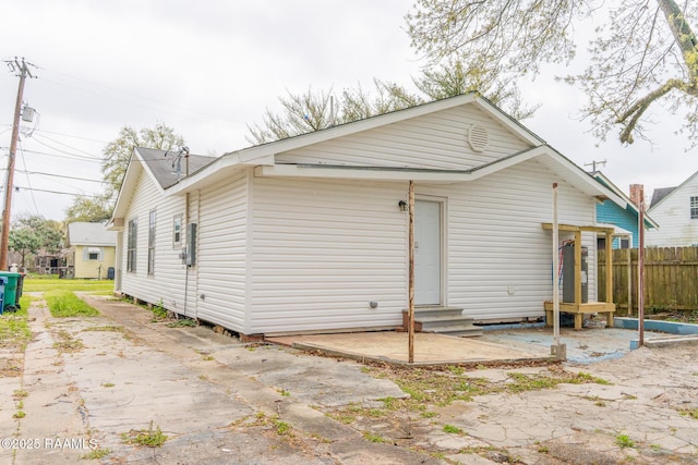 rear view of house with a patio area, fence, and entry steps