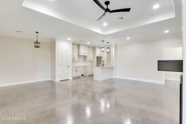 unfurnished living room featuring a raised ceiling, baseboards, concrete floors, and ceiling fan