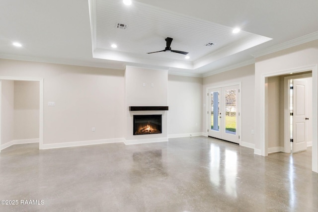 unfurnished living room with visible vents, a raised ceiling, baseboards, and finished concrete floors