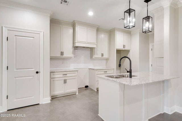 kitchen with light stone counters, visible vents, finished concrete floors, decorative backsplash, and a sink