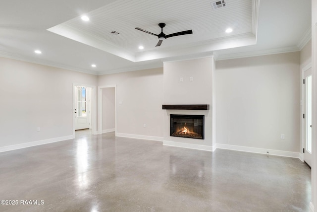 unfurnished living room with a tray ceiling, baseboards, visible vents, and concrete flooring