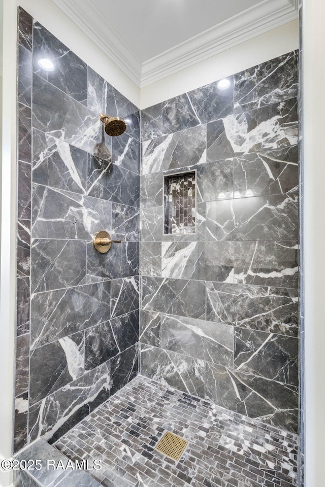 full bathroom with ornamental molding and a tile shower